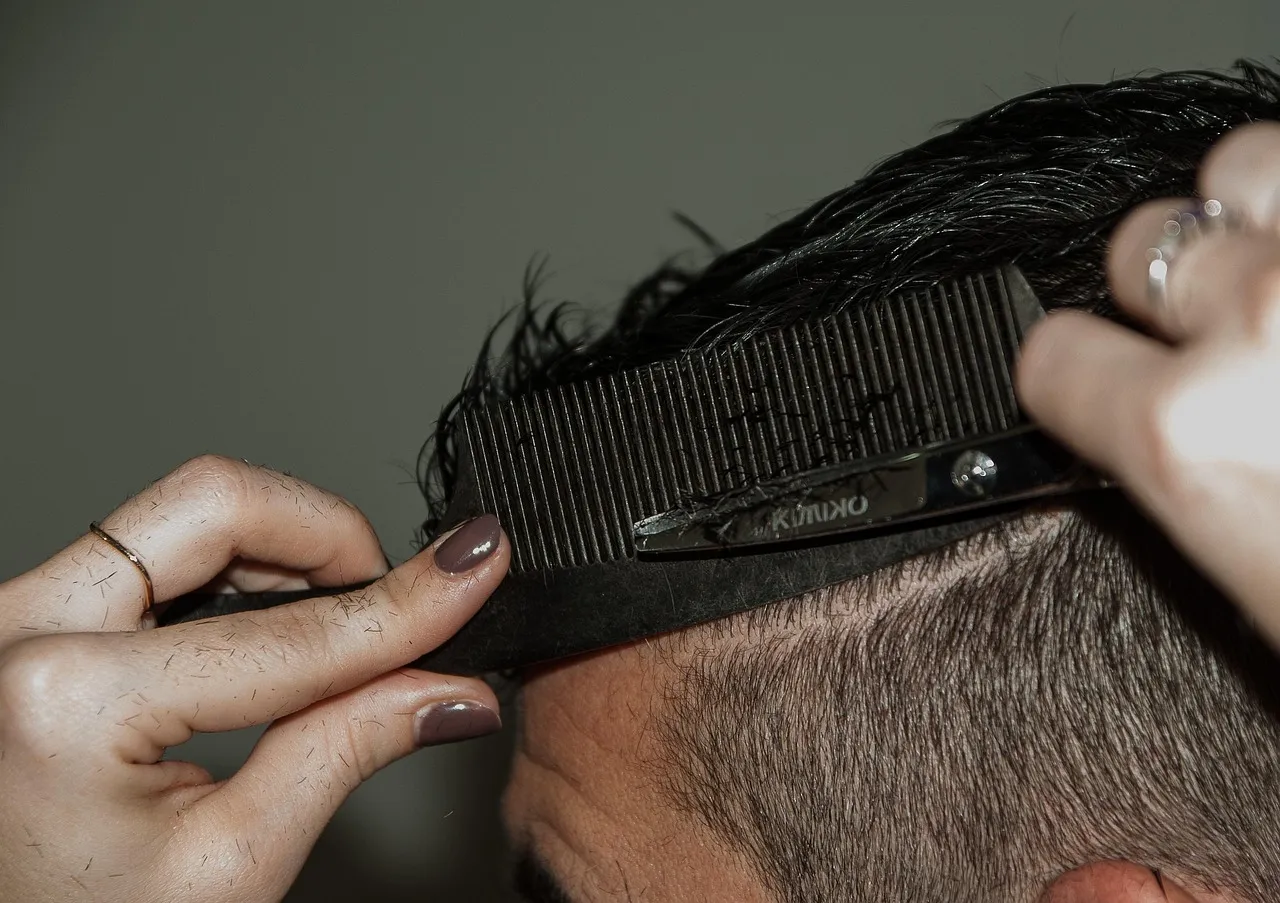 Scissors over comb on the side of a short fade